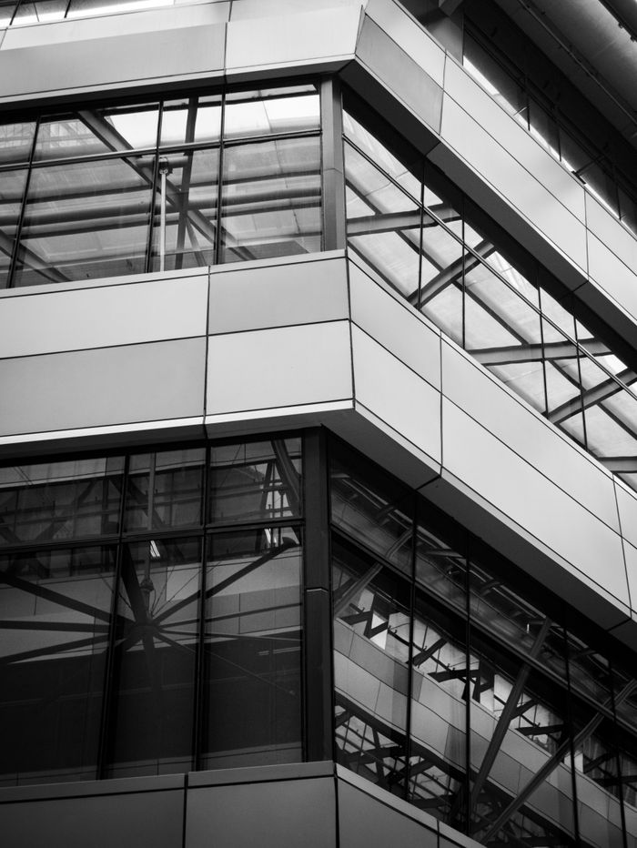 Abstract black and white view of modern glass architecture with geometric lines.