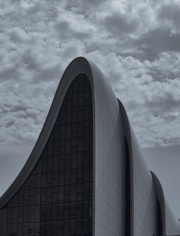 Stunning view of modern architectural structure in Baku under a dramatic sky.