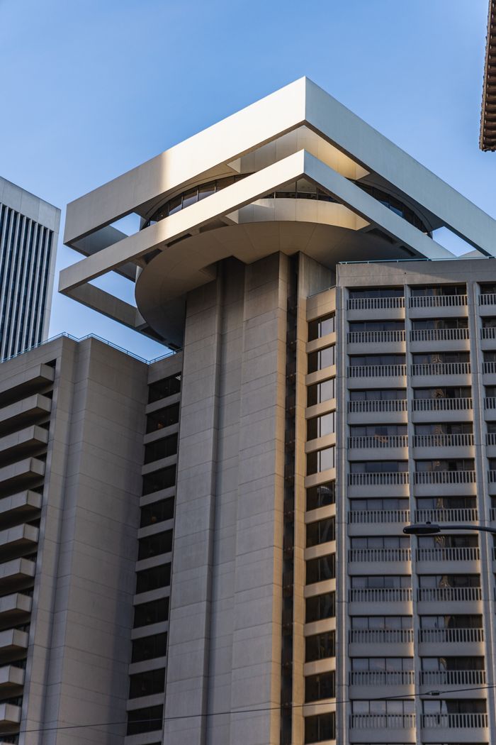 A striking modern tower featuring unique layered design against a clear sky.