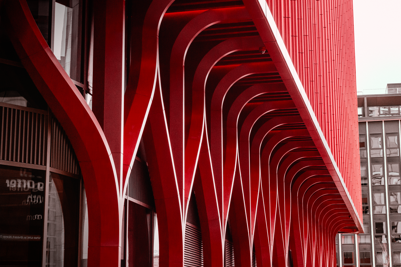 Dynamic red architectural facade in Birmingham, showcasing modern design elements.