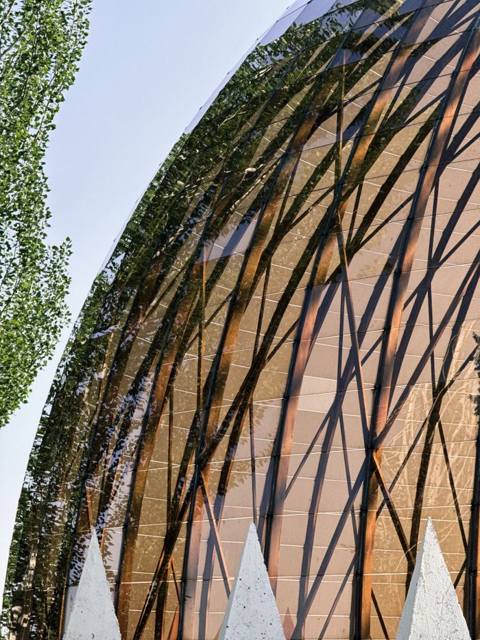 Contemporary building facade featuring abstract geometric patterns and glass reflections.